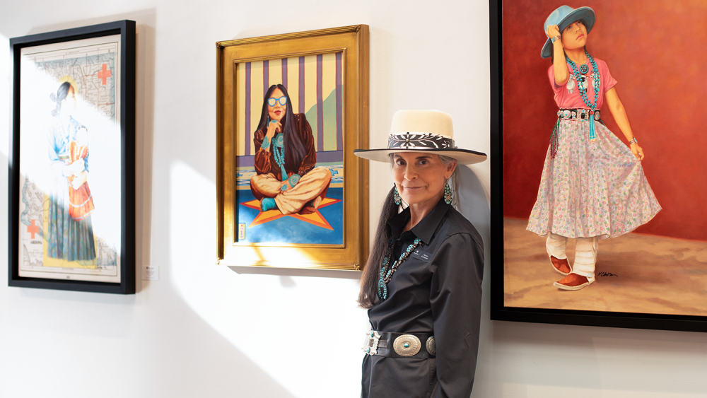 Karen Clarkson next to her paintings at Blue Rain Gallery